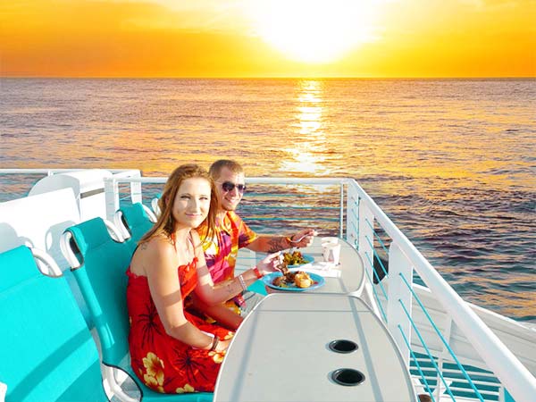 couple enjoying sunset catamaran dinner cruise calypso maui