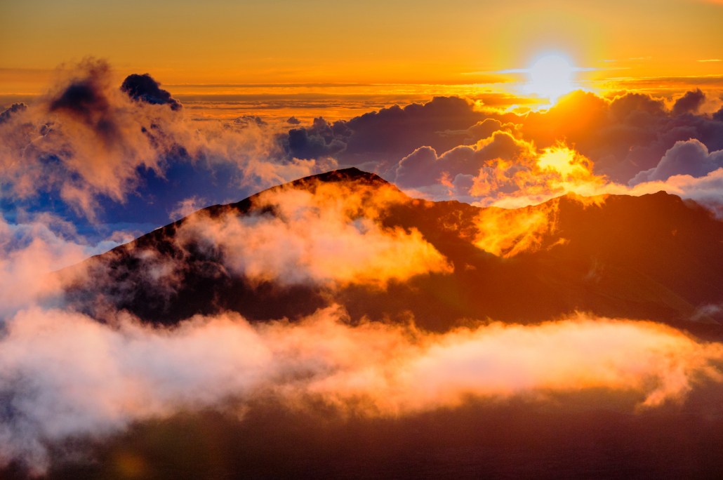 people watching clouds at sunrise from the top of haleakala crater on maui hawaii
