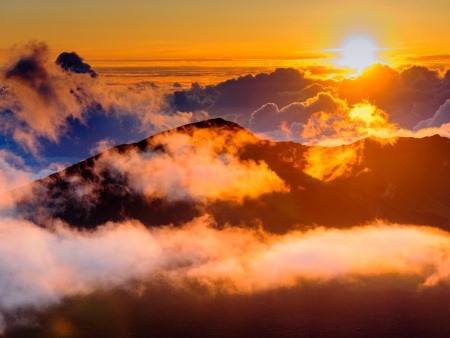 people watching clouds at sunrise from the top of haleakala crater on maui hawaii