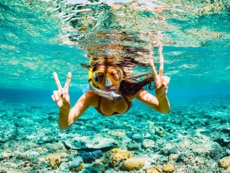 Snorkeler Underwater Ocean Reef Girl Hawaii shutterstock