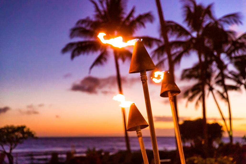 hawaii sunset with fire torches oahu luau