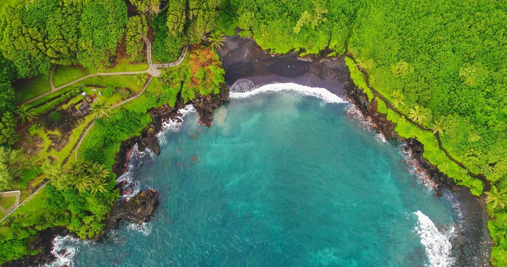 an aerial view of the black sand beach in waianapanapa state park along the road to hana in east maui