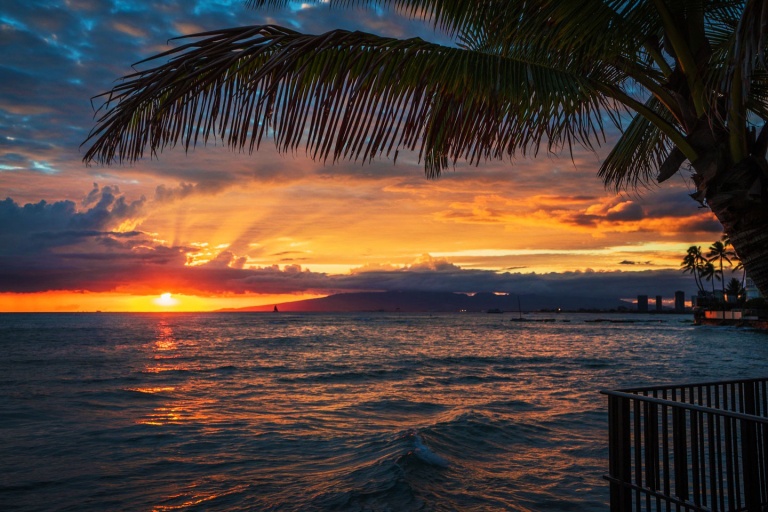 watching the sunset over Honolulu from a glass bottom boat oahu sunset tour