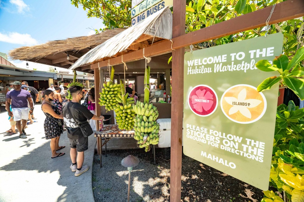 Polynesian Cultural Center Hukilau Marketplace Visitors Bananas and Sign Oahu