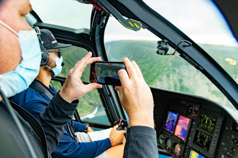 Kohala Coast Helicopter Tour Interior Pilot and Guest with Phone Big Island