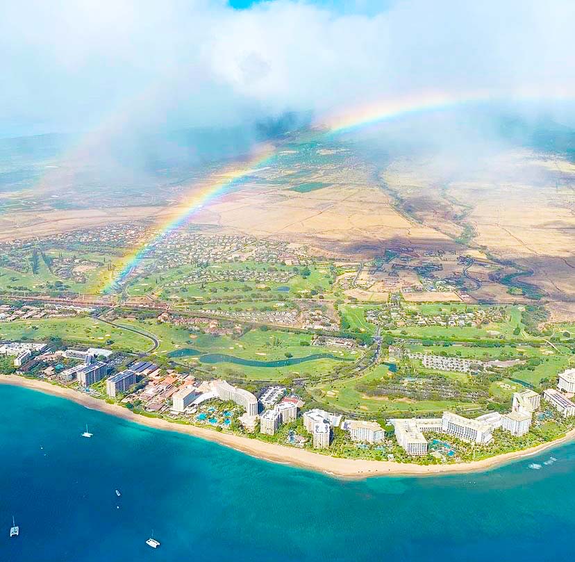 aerial view over west maui mountains with a rainbow air maui helicopter tours