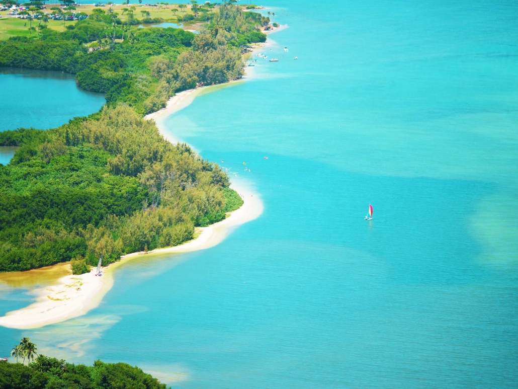 secret island beach shoreline with sail boat kaneohe kualoa hawaii oahu island