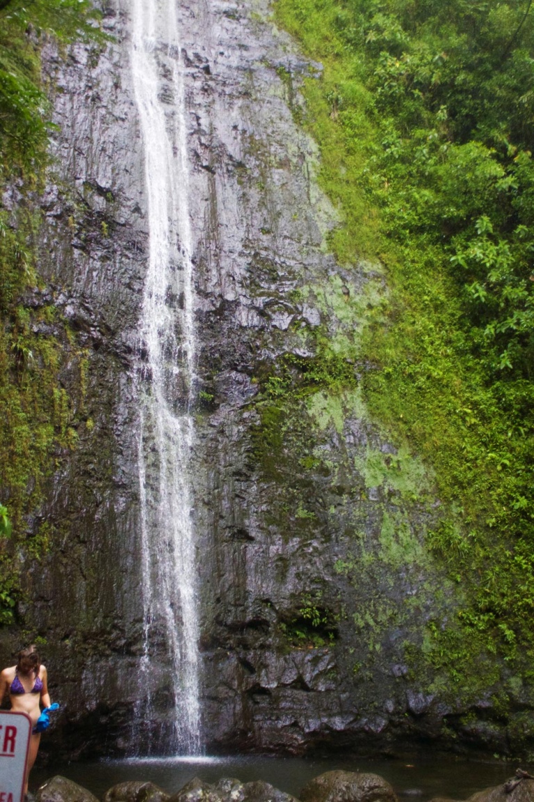 water cascades down from the mountain into a small pool kaimanatours