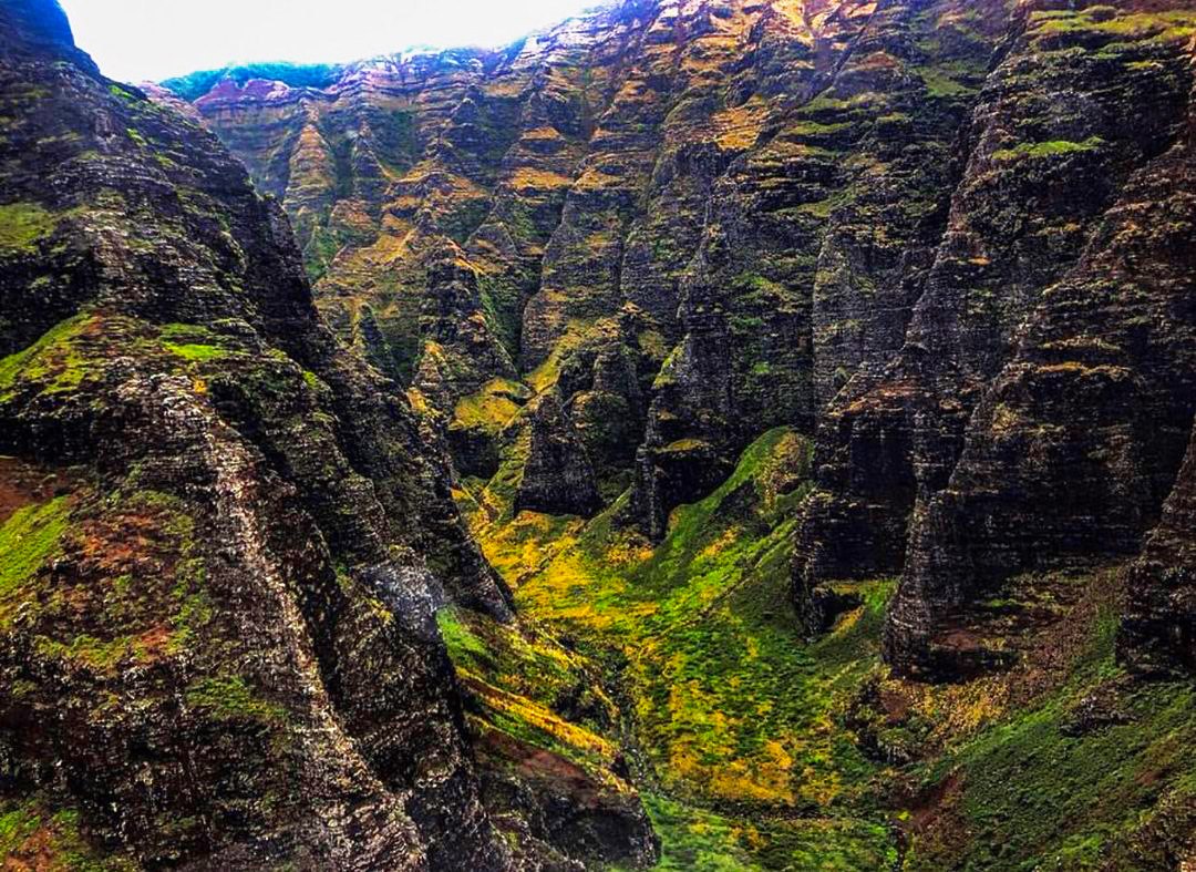 flying through canyons soar next to draping waterfalls on kauai sunshine helicopters