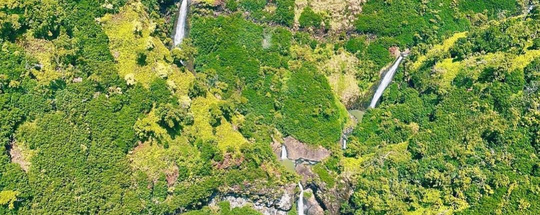 great shot of kauai waterfalls sunshine helicopters