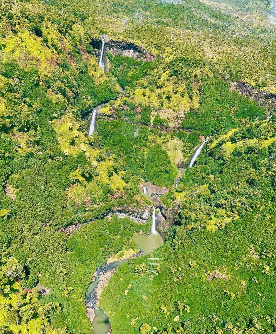 great shot of kauai waterfalls sunshine helicopters