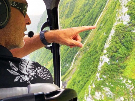pilot shaylan pointing out the goats on molokai on the doors off tour air maui helicopter tour