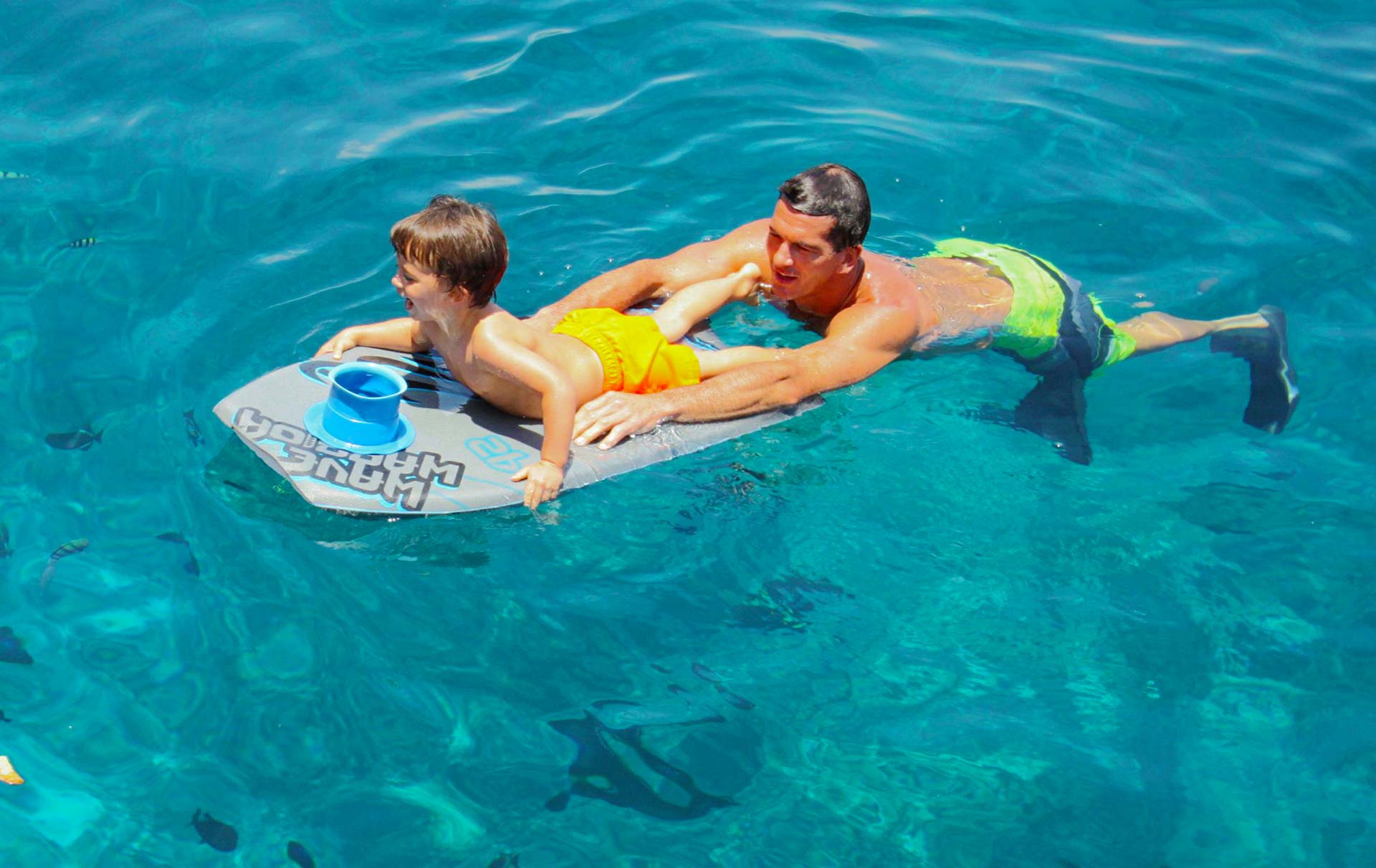 father and son enjoying flotation at the fair wind snorkel cruise