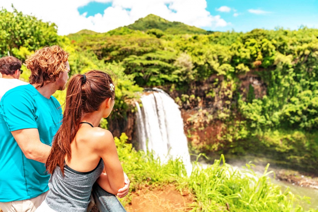 tourist visiting the wailua falls of kauai hawaii