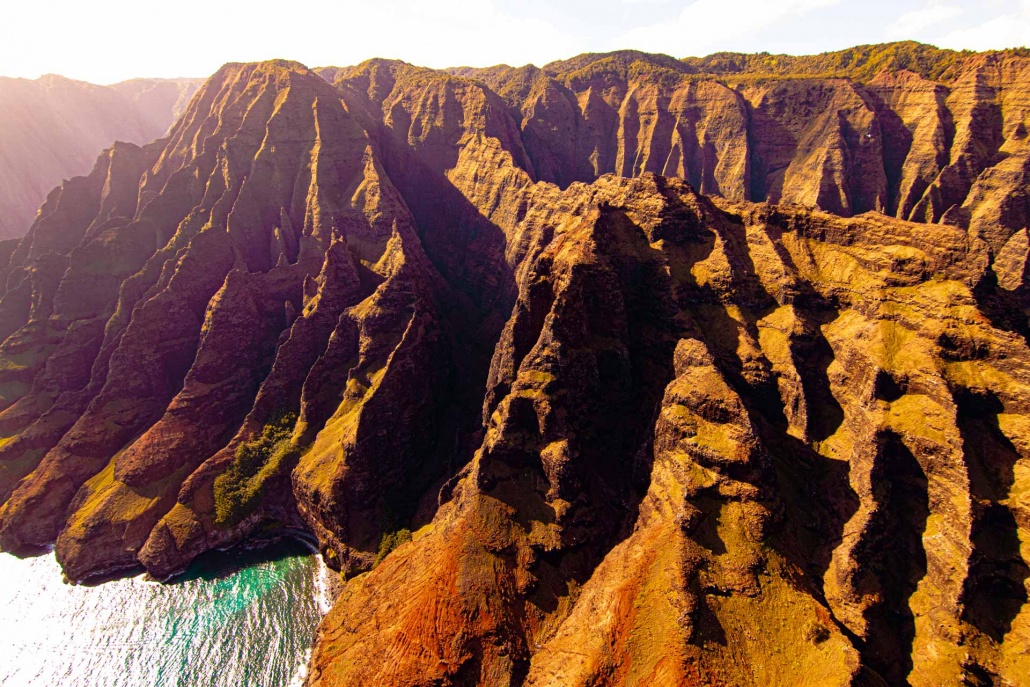 a serene stretch of coastline with towering sea cliffs of na pali coast kauai