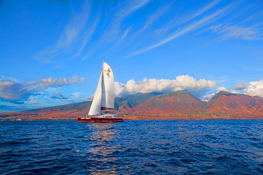 hula girl sunset sail high tech luxury sailing