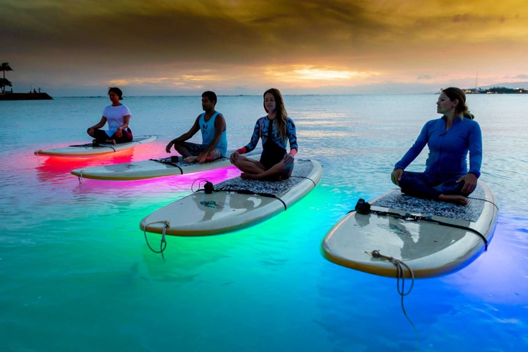 light up the night yoga combining sup and yoga gives you a full body workout oahu