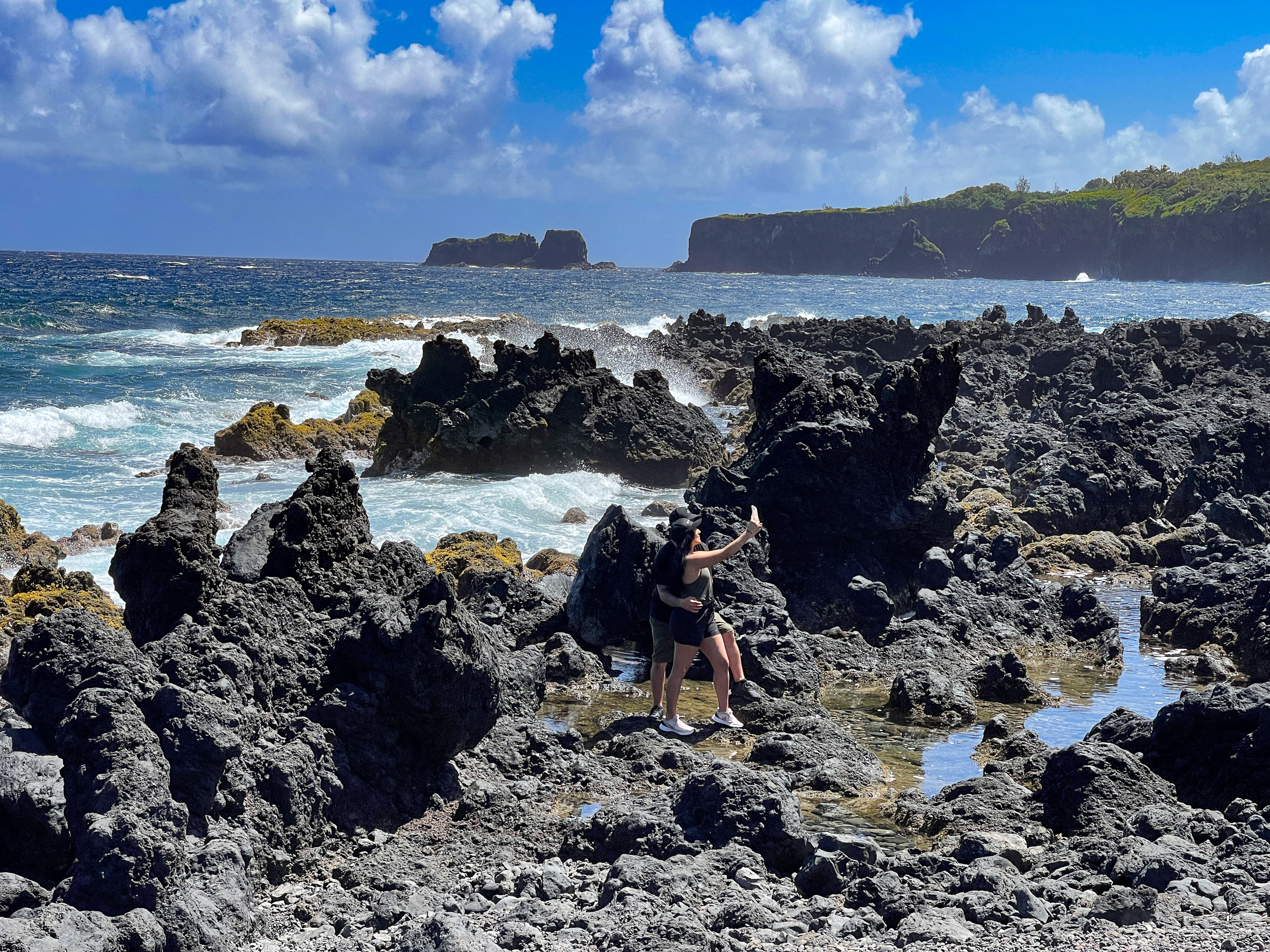 Cave in Hāna, Maui, used as a location mentioned in Chief of War, featuring natural rock walls and an opening to sunlight above.