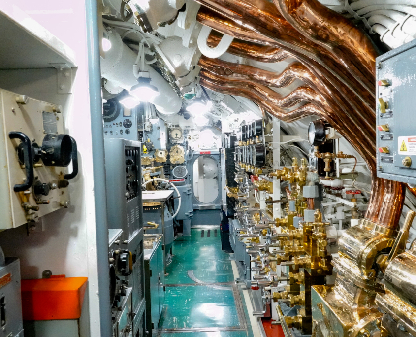 USS Bowfin submarine engine and control room with copper pipes and machinery at Pearl Harbor, Hawai‘i