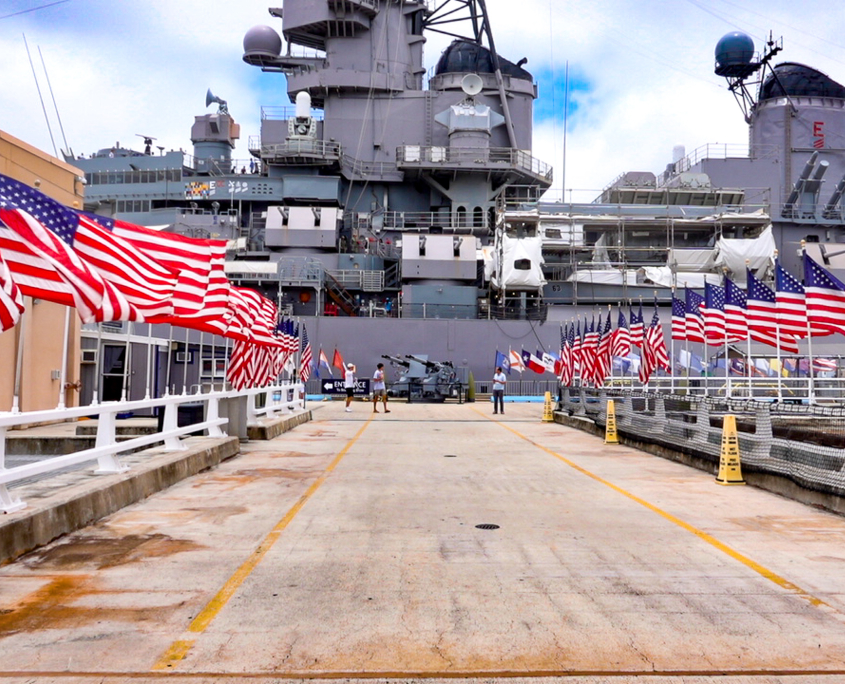 Entrance walkway to the USS Missouri battleship at Pearl Harbor lined with American flags