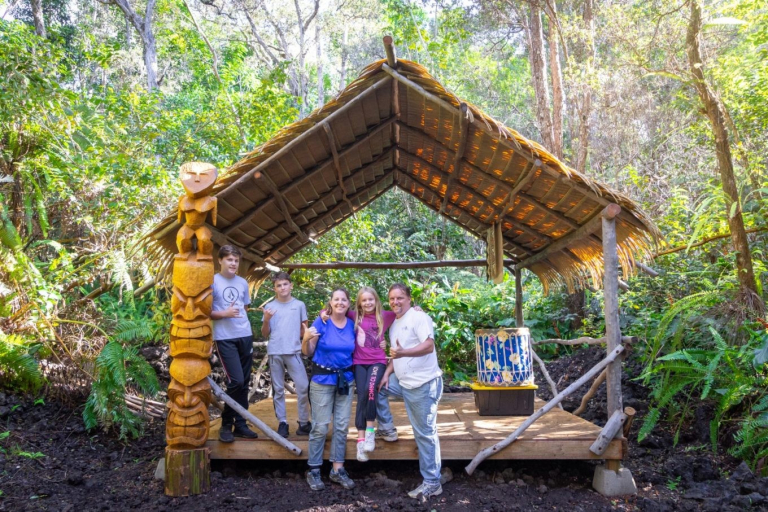 Aloha-Adventure-Farms-family-posing-under-wooden-shelter-in-forest