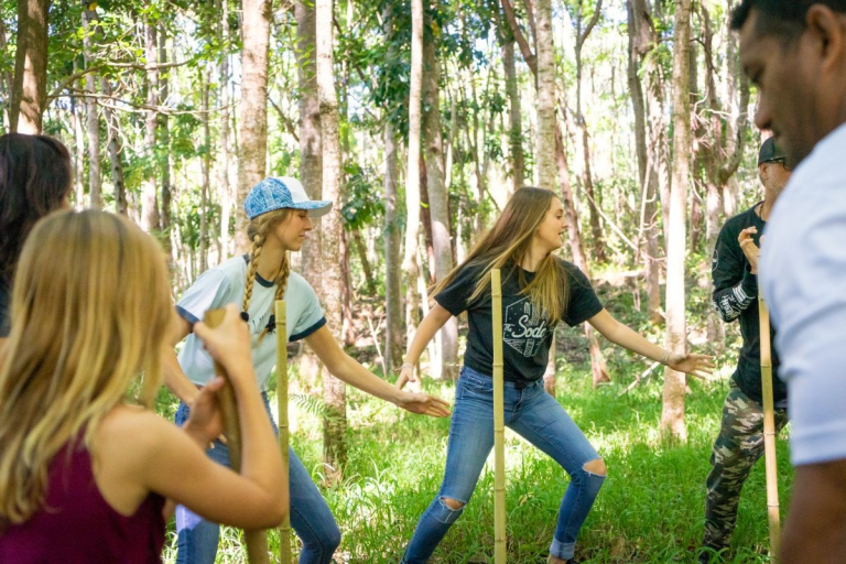 Aloha-Adventure-Farms-people-playing-game-with-sticks-in-forest-1