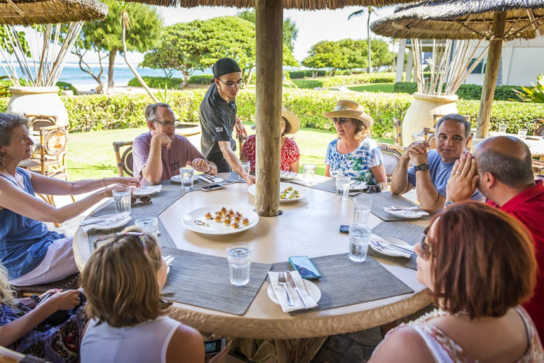 Tasting-Kauai-people-dining-outdoors-under-thatched-umbrellas-2