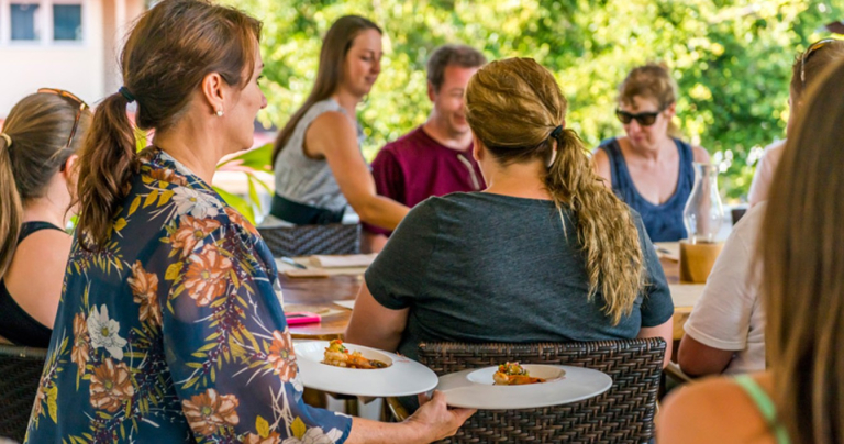 Tasting-Kauai-people-dining-outdoors-with-food-being-served-1