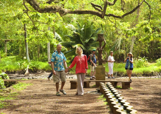 people exploring lush tropical garden trail