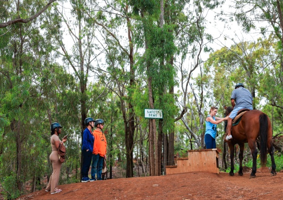 group of kids gettting ready for horseback riding